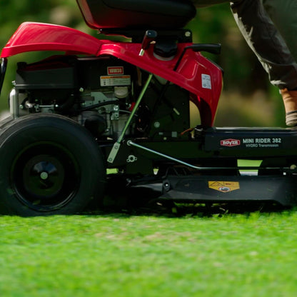 Red riding lawn mower on grass with a blurred background