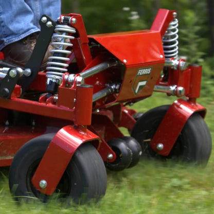 Red Ferris 300S ride on mower in action with front wheels turning and suspension rights in front of the drivers' feet.