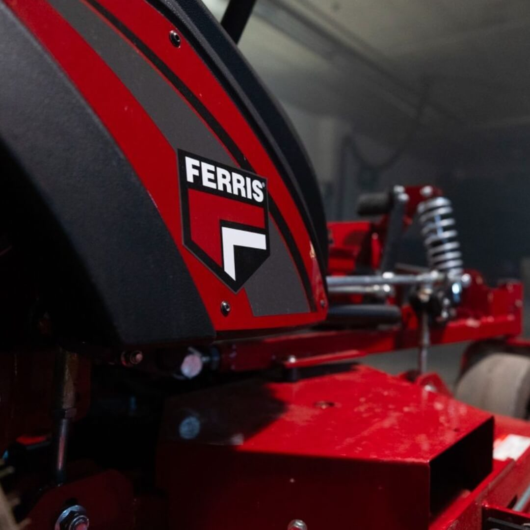 Red lawn mower with Ferris logo in a garage setting