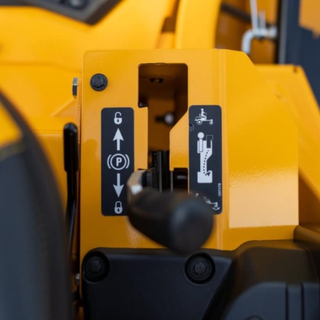 Close-up of a yellow machine with control levers and labels